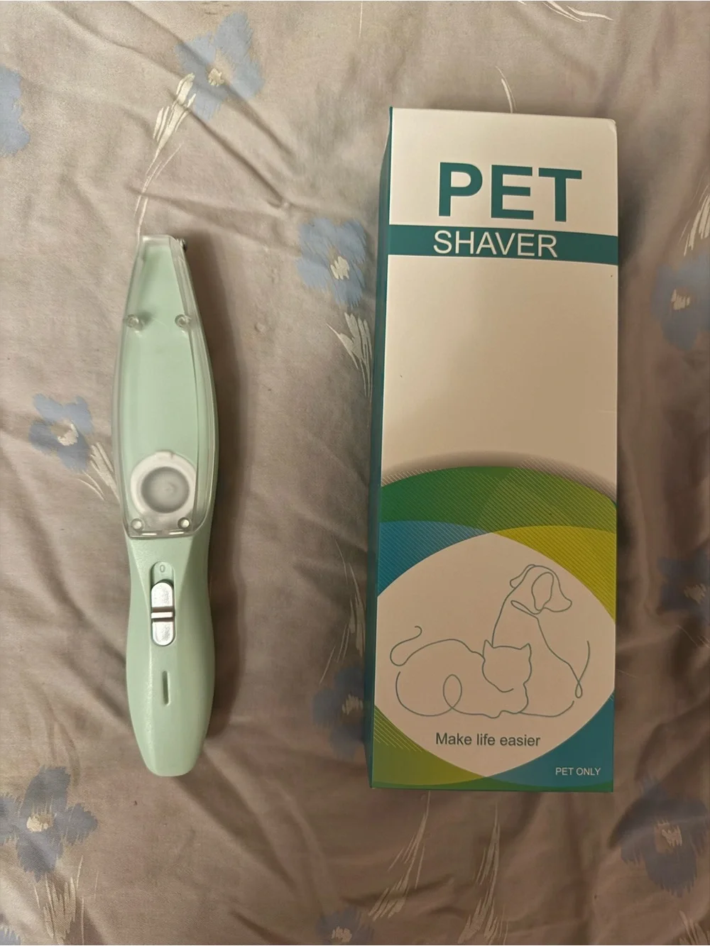This a green electric pet shaver designed for trimming hair on dogs and cats.